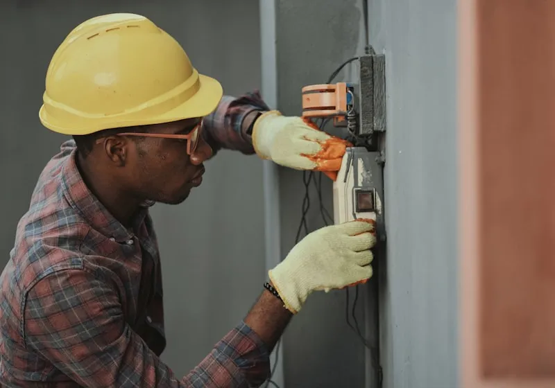 An electrician working on a panel