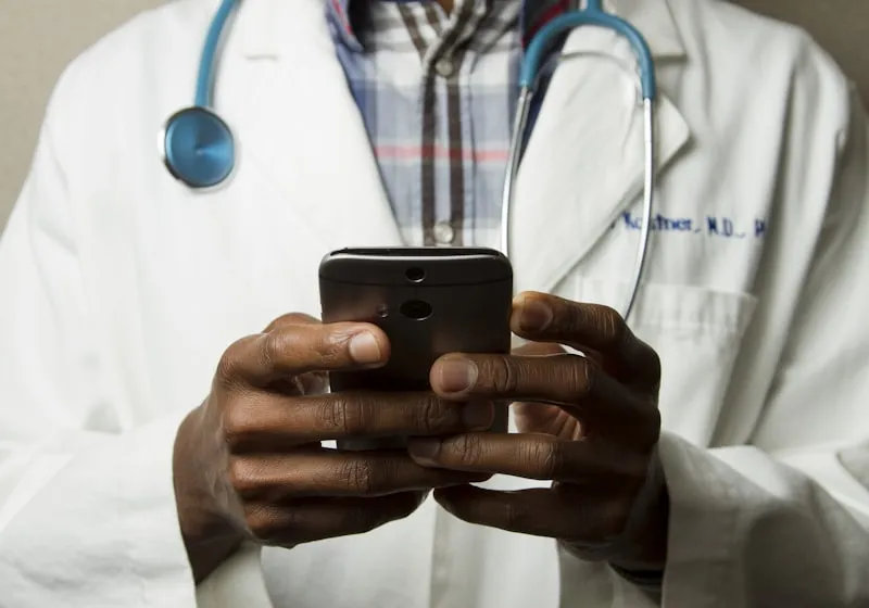 A doctor holding a phone