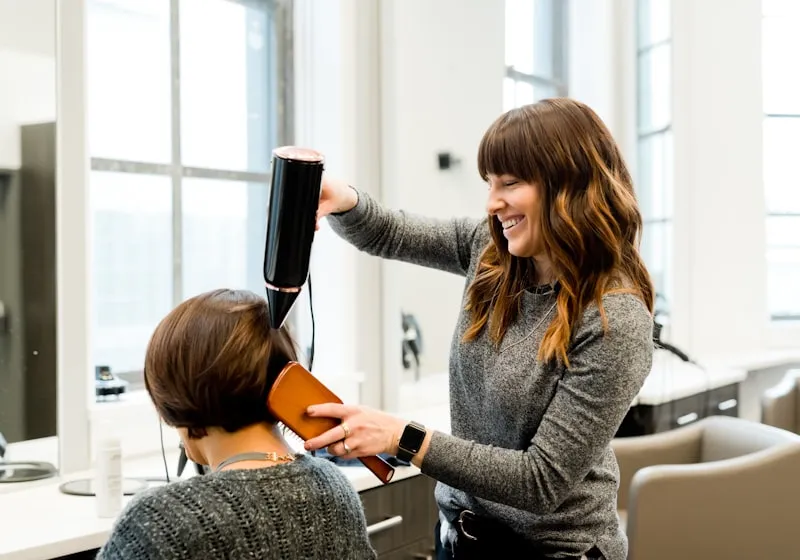 A stylist with a client in a salon